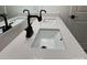 Close-up of bathroom vanity featuring double sinks, black faucets, and quartz countertop at 3014 Cunningham Farm Dr, Indian Trail, NC 28079