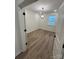 A bright bedroom featuring wood floors, a modern light fixture, and a view from the window at 3014 Cunningham Farm Dr, Indian Trail, NC 28079