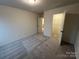 Cozy bedroom features neutral carpeting, a walk-in closet, and natural light at 3014 Cunningham Farm Dr, Indian Trail, NC 28079