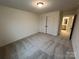 Comfortable bedroom boasts neutral carpeting, a closet, and entry to the bathroom at 3014 Cunningham Farm Dr, Indian Trail, NC 28079