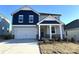Two-story home with gray and blue siding, a white door, and a two-car garage at 3014 Cunningham Farm Dr, Indian Trail, NC 28079