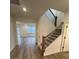 The foyer features wood-look floors, a staircase with wood handrail and iron spindles at 3014 Cunningham Farm Dr, Indian Trail, NC 28079