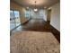 An open living space with plenty of windows and wood look flooring at 3014 Cunningham Farm Dr, Indian Trail, NC 28079
