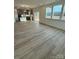 Open-concept living area with wood-look flooring and large windows providing natural light at 3014 Cunningham Farm Dr, Indian Trail, NC 28079