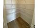 Walk-in pantry with multiple wire shelves for ample storage and wood look flooring at 3014 Cunningham Farm Dr, Indian Trail, NC 28079