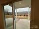 Covered patio overlooking a well-manicured lawn and picturesque natural scenery at 3014 Cunningham Farm Dr, Indian Trail, NC 28079