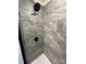Modern shower featuring gray stone-look tile and a matte black shower head at 3014 Cunningham Farm Dr, Indian Trail, NC 28079