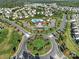 Aerial view of the community clubhouse and pool nestled in a neighborhood at 7248 Waterwheel Sw St, Concord, NC 28025