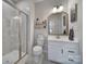 Bathroom with white vanity, shower, and framed mirror at 7248 Waterwheel Sw St, Concord, NC 28025