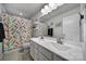 Bright bathroom with double sink vanity, mermaid themed shower curtain and tile flooring at 7248 Waterwheel Sw St, Concord, NC 28025