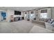 Bonus room featuring neutral carpet, a tv, and white curtains at 7248 Waterwheel Sw St, Concord, NC 28025