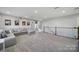 Neutral carpeted bonus room, with stairway to the right at 7248 Waterwheel Sw St, Concord, NC 28025