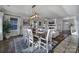 Bright dining area adjacent to the living room, with modern lighting and ample natural light at 7248 Waterwheel Sw St, Concord, NC 28025