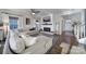 Cozy living room featuring a fireplace, comfortable sectional, and bright windows at 7248 Waterwheel Sw St, Concord, NC 28025