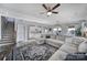Spacious open-concept living room with hardwood floors, leading to the kitchen and dining area at 7248 Waterwheel Sw St, Concord, NC 28025