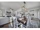 Open-concept living and dining room with white walls, fireplace, and modern lighting fixtures at 7248 Waterwheel Sw St, Concord, NC 28025