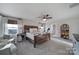 Inviting bedroom with a wooden bed frame, cozy armchairs, and bright natural light at 7248 Waterwheel Sw St, Concord, NC 28025