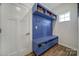 Mudroom with a custom blue storage bench and coat hooks at 7248 Waterwheel Sw St, Concord, NC 28025