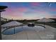 Backyard pool with patio, umbrellas, and a beautiful sunset view at 7248 Waterwheel Sw St, Concord, NC 28025