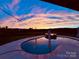 Backyard pool with patio, umbrellas, and amazing sky at 7248 Waterwheel Sw St, Concord, NC 28025
