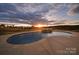 Stunning pool with a captivating sunset view, perfect for relaxation and outdoor enjoyment at 7248 Waterwheel Sw St, Concord, NC 28025