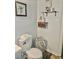 Well-decorated bathroom with a toilet, storage basket, and decorative wall art at 106 S Inman Ave, Bessemer City, NC 28016