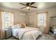 Comfortable bedroom featuring soft lighting, plush bedding, and large windows for a bright and airy feel at 106 S Inman Ave, Bessemer City, NC 28016