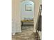 Inviting hallway featuring an arched entrance, decorative vase, wooden bench, and modern decor at 106 S Inman Ave, Bessemer City, NC 28016