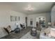 Cozy living room featuring wood-look floors, modern furniture, and an open layout to the kitchen and dining areas at 106 S Inman Ave, Bessemer City, NC 28016