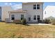 A view of the back exterior with a concrete patio and lush, green lawn at 1109 Freeman View Dr, Albemarle, NC 28001