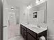 Modern bathroom featuring a double sink vanity, large mirror, and neutral tile flooring at 1109 Freeman View Dr, Albemarle, NC 28001