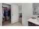 Bathroom featuring a walk-in closet, vanity with countertop, and doorway leading to another room at 1109 Freeman View Dr, Albemarle, NC 28001