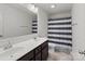 Bathroom featuring double sinks, a large mirror, and a shower with a striped curtain at 1109 Freeman View Dr, Albemarle, NC 28001
