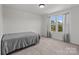 Neutral bedroom with carpet flooring, natural light, and window views of the surrounding greenery at 1109 Freeman View Dr, Albemarle, NC 28001