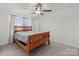 Bedroom with a ceiling fan and natural light flooding in from a window above a wood-framed bed at 1109 Freeman View Dr, Albemarle, NC 28001