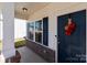 A charming front door with a festive wreath, brick accents and security features at 1109 Freeman View Dr, Albemarle, NC 28001