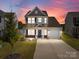 Charming two-story home featuring a well-manicured lawn and a welcoming front porch with brick accents at 1109 Freeman View Dr, Albemarle, NC 28001