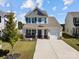 Charming two-story home featuring a well-manicured lawn and a welcoming front porch with brick accents at 1109 Freeman View Dr, Albemarle, NC 28001