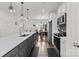 Modern kitchen with stainless steel appliances, gray cabinets, and a large island with a white countertop at 1109 Freeman View Dr, Albemarle, NC 28001