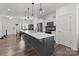 Bright kitchen featuring a large island with seating, stainless steel appliances, and modern pendant lights at 1109 Freeman View Dr, Albemarle, NC 28001