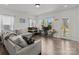 Inviting living room featuring a comfortable gray couch, natural light, and modern decor at 1109 Freeman View Dr, Albemarle, NC 28001