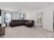 Bright living room with neutral carpet, large sofa, and windows providing plenty of natural light at 1109 Freeman View Dr, Albemarle, NC 28001