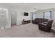 Cozy living room with comfortable seating, entertainment center, and ample natural light from the windows at 1109 Freeman View Dr, Albemarle, NC 28001