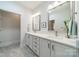 Bright bathroom featuring double sink vanity with framed mirrors, stylish fixtures and neutral paint at 2014 Newstyle Way, Tega Cay, SC 29708