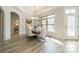 Dining room with modern chandelier, marble table, chairs, and natural lighting from a large window at 2014 Newstyle Way, Tega Cay, SC 29708