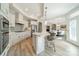 Eat-in kitchen with stainless steel appliances, white cabinetry, island, and bar stool seating at 2014 Newstyle Way, Tega Cay, SC 29708