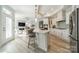 Spacious kitchen with white cabinets and island, open layout connecting to the adjacent living room at 2014 Newstyle Way, Tega Cay, SC 29708