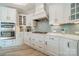 Bright eat-in kitchen with white cabinets, stylish tile backsplash, and modern stainless steel appliances at 2014 Newstyle Way, Tega Cay, SC 29708
