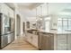 Kitchen island with stainless steel sink, dishwasher, breakfast bar, and pendant lighting at 2014 Newstyle Way, Tega Cay, SC 29708