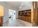 Open library features a large wooden bookcase and a view of the adjacent dining area, highlighting the home's open layout at 2014 Newstyle Way, Tega Cay, SC 29708